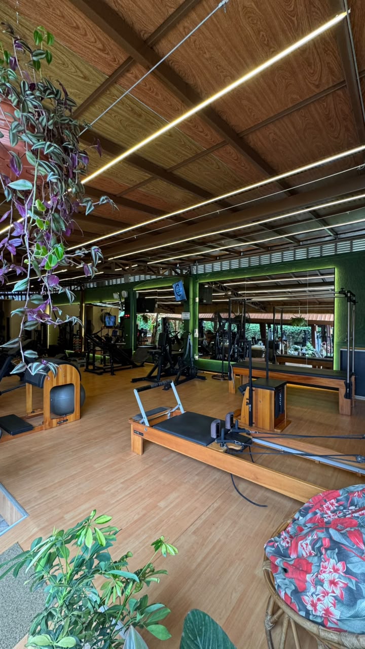 Sala ampla de Pilates integrada à área de musculação